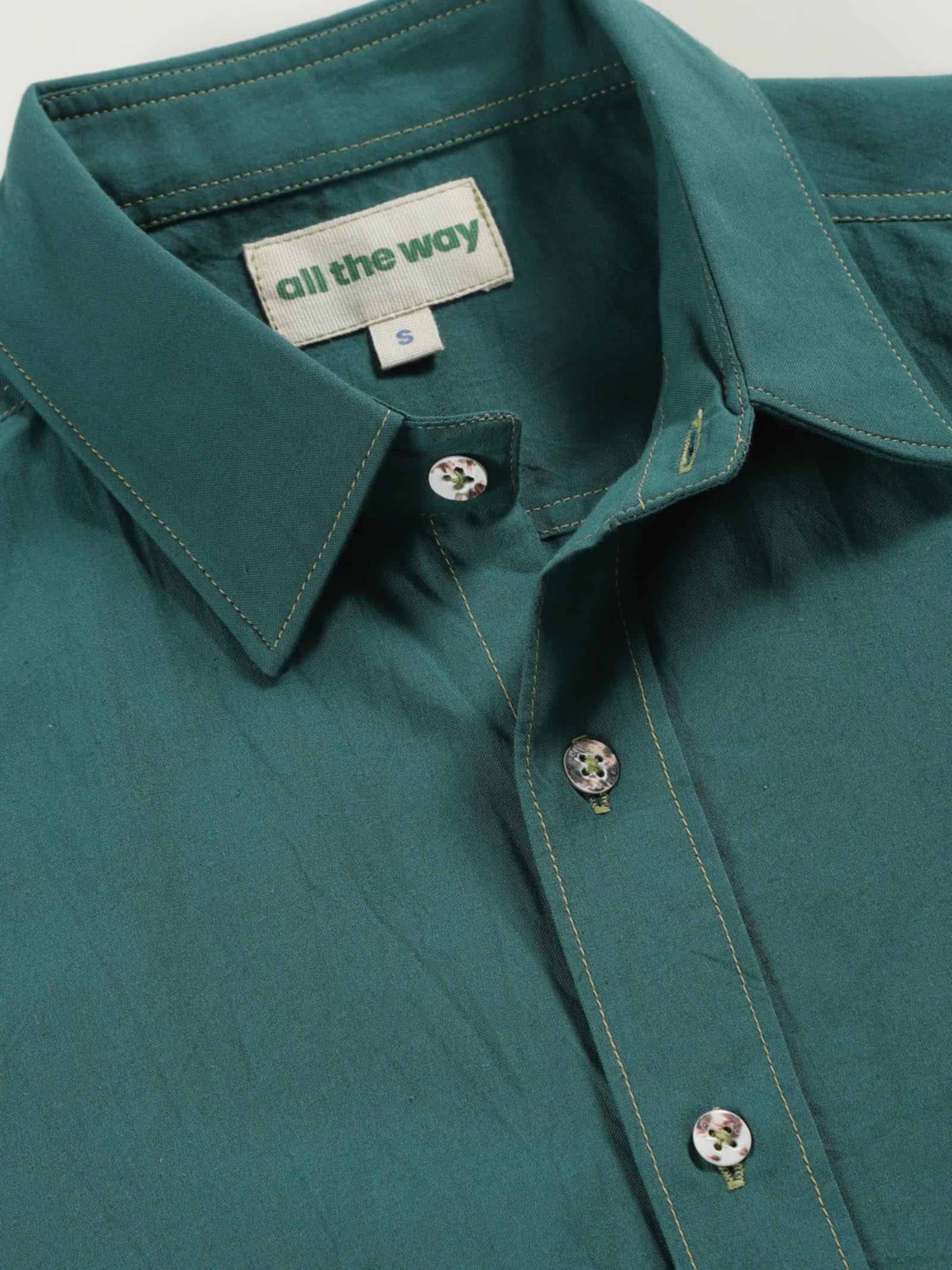 Close-up of old forest organic cotton shirt with organic cotton label printed in water-based ink, natural wooden buttons and contrast threads